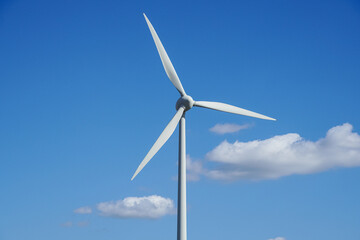 Wind turbine blades on blue sky background