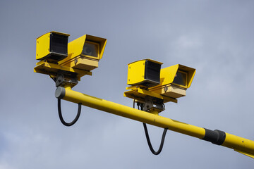 Yellow traffic speed control cameras on a road