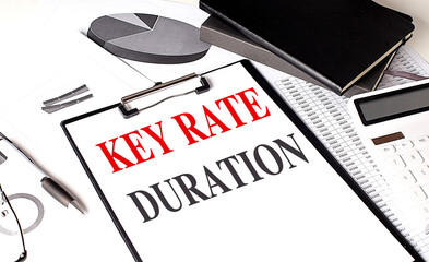 KEY RATE DURATION text on clipboard on chart background