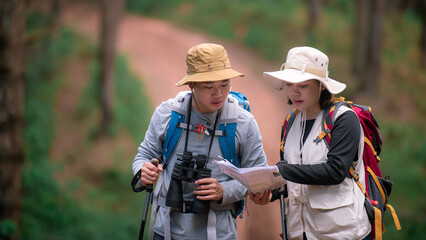 Close up of Hiking Couple backpacker in the pine forest.