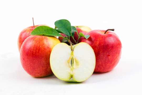 red apples with leaves on white background