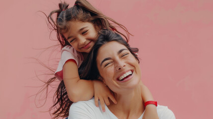 Joy radiates from a smiling woman with a young girl playfully perched on her shoulders against a pink background.