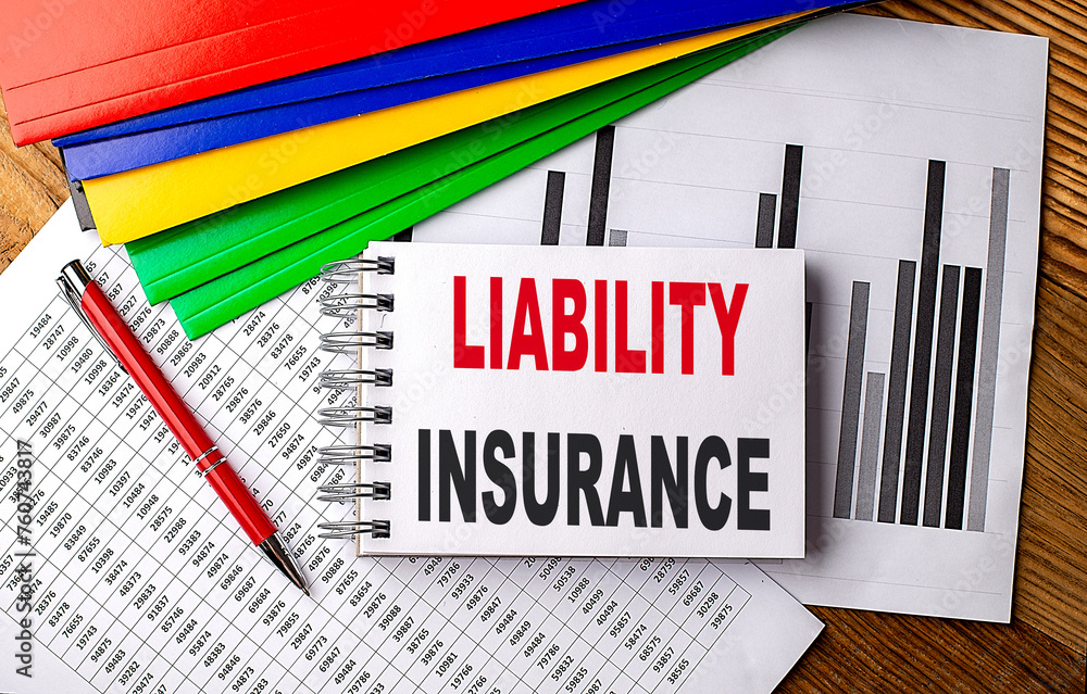 Poster liability insurance text on notebook with folder on chart