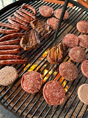 various meat and sausages on the charcoal grill
