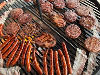 various meat and sausages on the charcoal grill