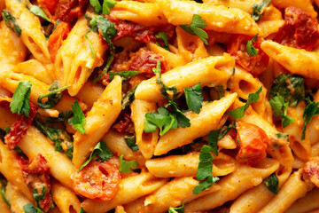 Homemade One-Pot Creamy Tuscan Pasta on a Plate, top view. Close-up.