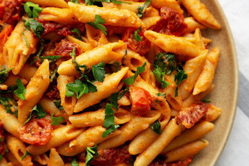 Homemade One-Pot Creamy Tuscan Pasta on a Plate, top view. Flat lay, overhead, from above.