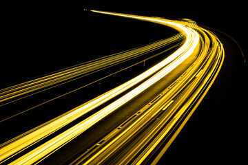 gold car lights at night. long exposure