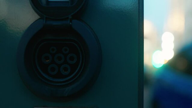 Technological Advancement: Close-Up of Car's Electric Blue Charging Port, Symbolizing Automotive Evolution