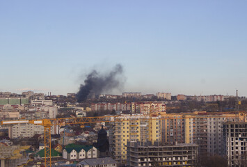 Obraz premium Urban Skyline with Smoke Plume