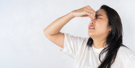 A woman with a runny nose. Asian woman suffering from stuffy nose having runny nose.