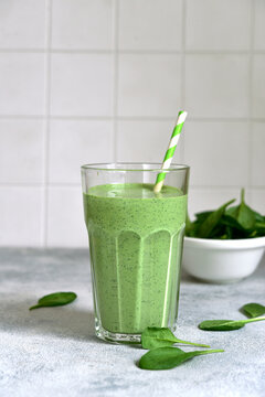 Detox spinach smoothie in a tall glass. Top view with copy space.