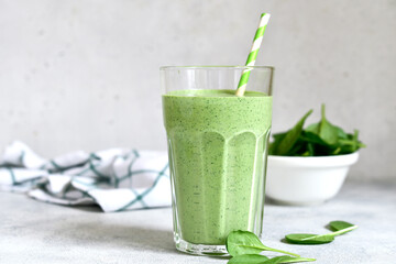 Detox spinach smoothie in a tall glass. Top view with copy space.