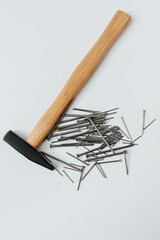 A hammer with nails lie on a white background. space for text