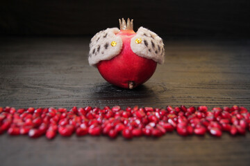 Pomegranate is the king of fruit. Imitation of a king in a royal robe, with a crown on his head. An allegory on the theme, the monarch before his subjects, acts as an authoritative leader of the natio