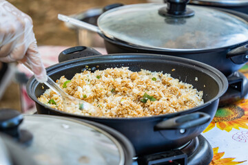 Hand serving korean fried rice. Asian street food.