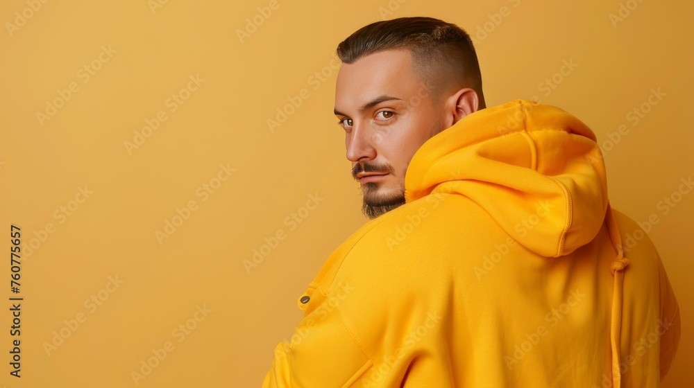 Wall mural smiling young man in sportswear, exuding active lifestyle, on pastel background with copy space