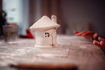 A handcrafted clay house sits proudly on display, showcasing the charming results of creativity and...