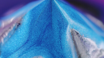 Glitter pyramid. Paint spill. Defocused neon blue purple silver color glowing shimmering particles...