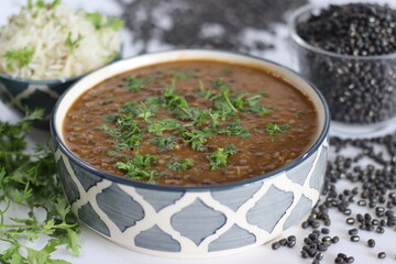 Flavorful maa ki dal paired with fragrant jeera rice, authentic Indian dish, vegetarian cuisine.