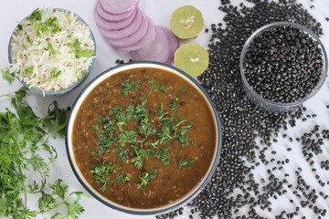 Flavorful maa ki dal paired with fragrant jeera rice, authentic Indian dish, vegetarian cuisine.