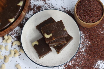 Slices of Ragi Halwa served in a round wooden tray