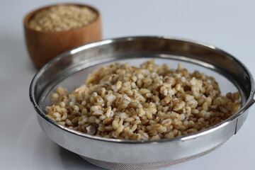 Soaked whole grain hulled barley in the strainer.