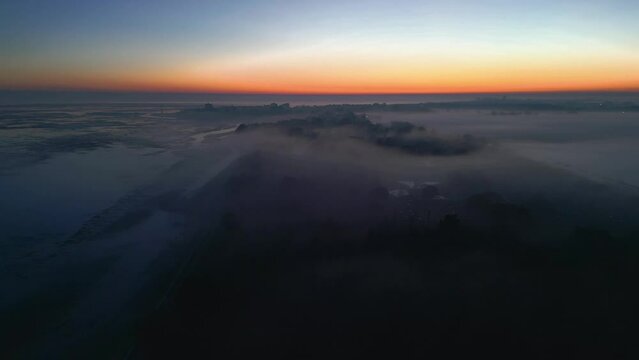 Grado lagoon above the fog. The city of Grado towards sunset.