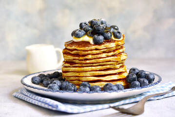 Stack of fresh hot pancakes with maple syrup and blueberries. - 760779025