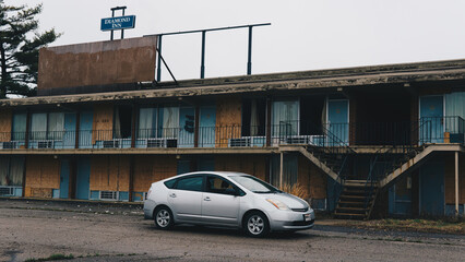 abandoned motel with car outside