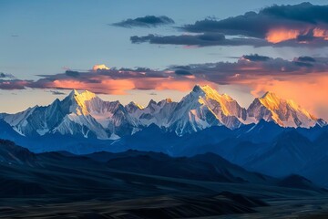A panoramic view of a majestic mountain range at sunset With the last rays of sunlight casting golden hues over the snowy peaks - obrazy, fototapety, plakaty