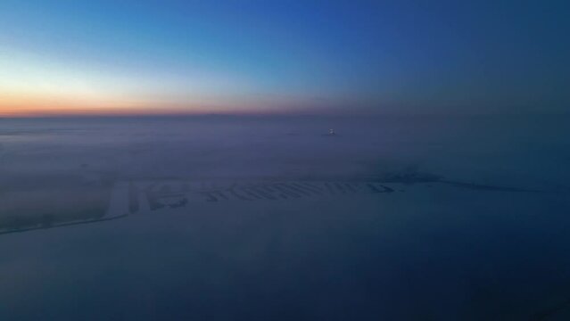 Grado lagoon above the fog. The city of Grado towards sunset.
