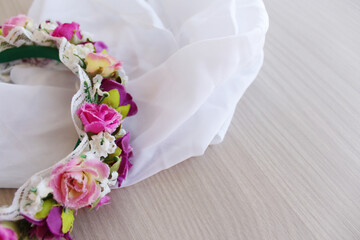 Horizontal background with white tissue and floral decoration for Mother's Day, International Women's Day or wedding banner invitation card. Bride veil with pink flower tiara. © AnaRosa