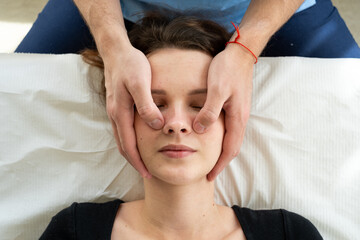 Facial massage, the doctor presses on the points on the face.