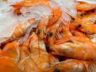 Red juicy boiled shrimp on ice