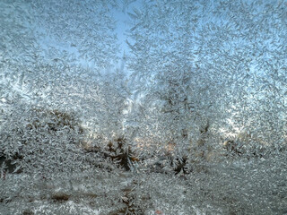 Frosty patterns on glass on a winter morning