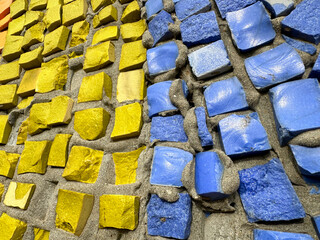 Yellow and blue stones are smeared on the wall