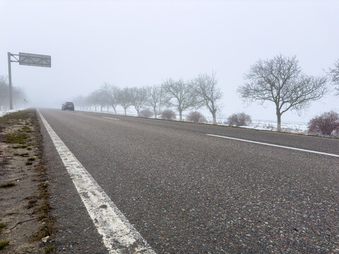 A thick fog hung over the road