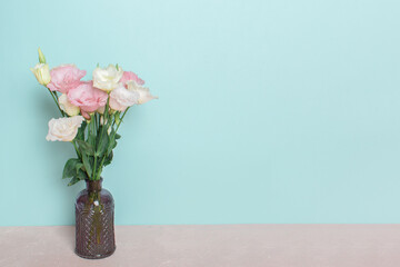 A bouquet of pink and white eustoma flowers in a vase