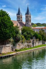 Beautiful view of the banks of the Seine River in the city of Melun and the Collegiate Church of Notre Dame. Melun, Seine-et-Marne department, France.  - obrazy, fototapety, plakaty