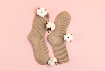 Wool knitted socks on pink background