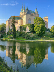 Medieval Bojnice Castle in Slovakia, central Europe, owned by family of Palfi. Lake reflection. 