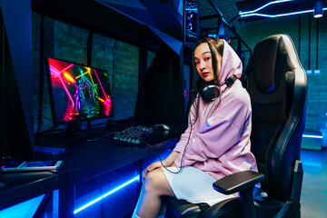 Beautiful young asian woman playing videogames at computer