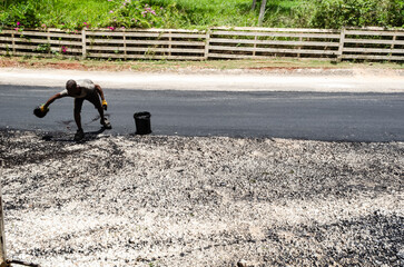 Man Oiling Roadway