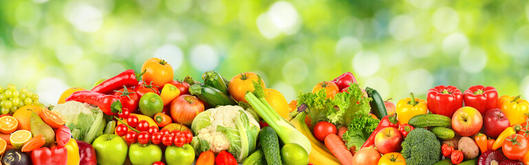 Large collection of fruits, berries and vegetables on green