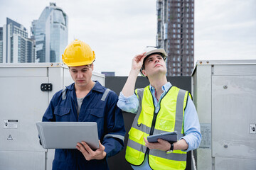 A group of engineers is inspecting the air conditioning cooling system of a large building or...