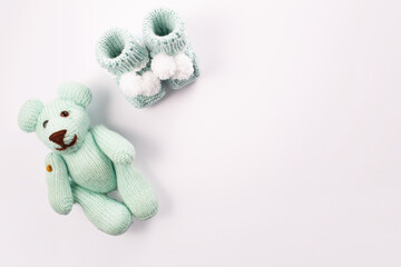 Baby socks and teddy bear on white background. Baby boy birth. Greeting card.Pregnancy announcement. Flatlay, top view