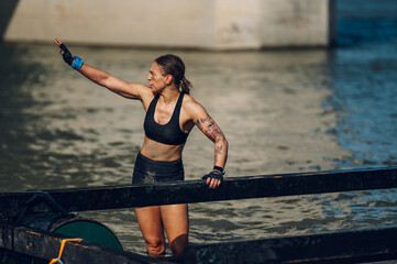 Portrait of a muscular female participating in an obstacle course race outdoor