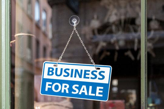 Business for sale sign in a store window