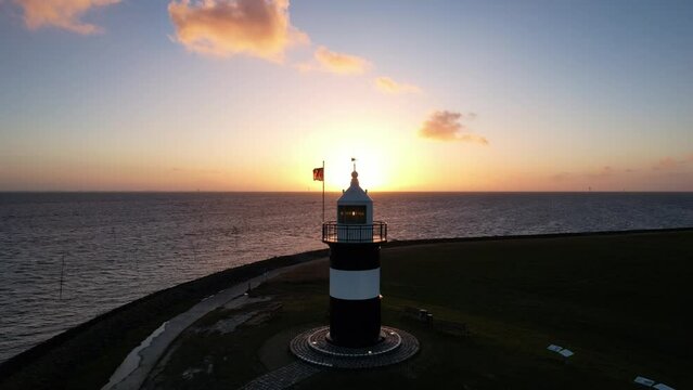 Lighthouse in the sunset - Wremen - Little Prussia lighthouse - Aerial shot over the lighthouse in the sunset